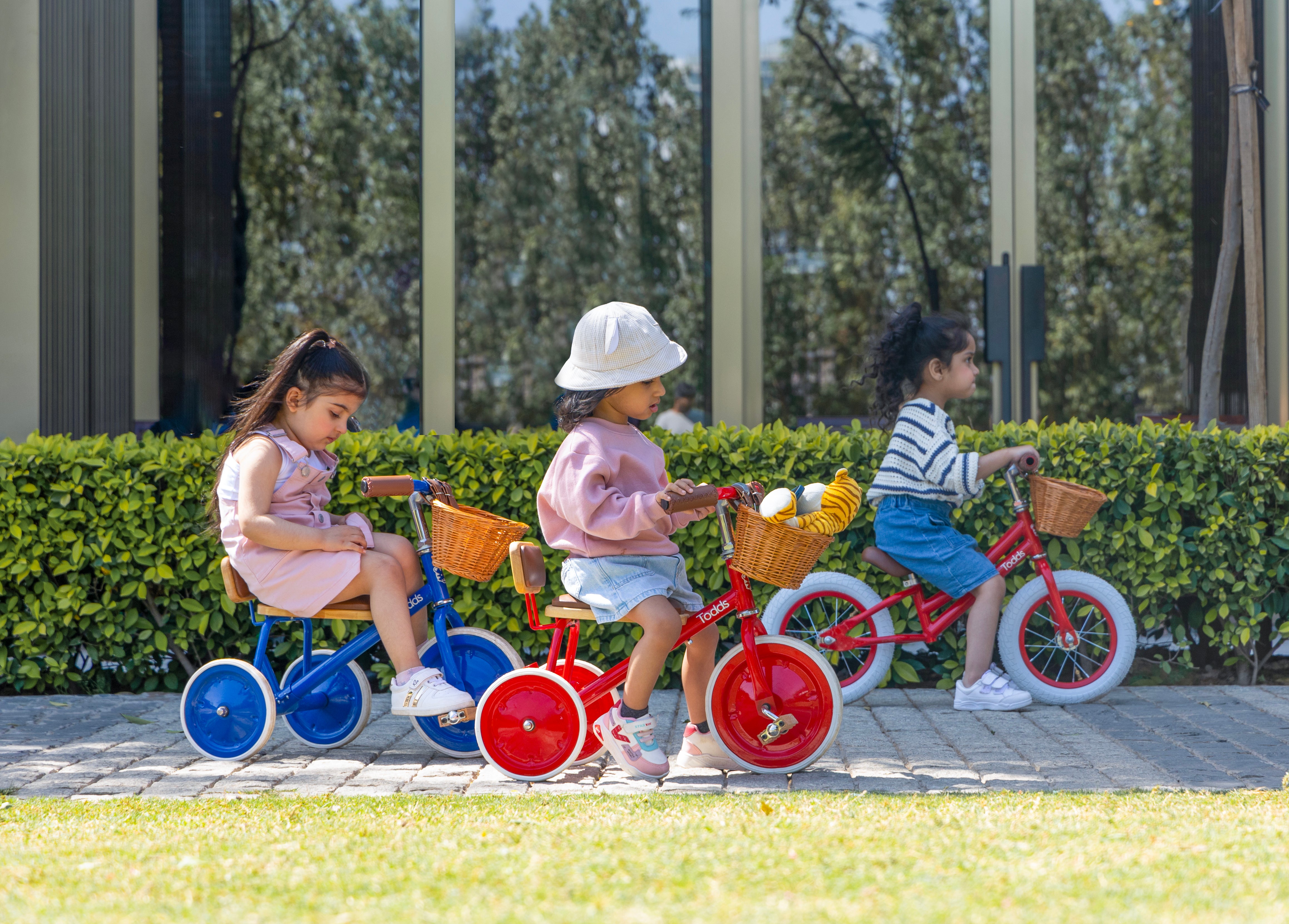 kids-riding-tricycle-in-park